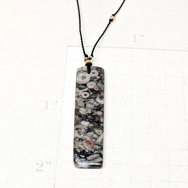 Mottled Black Crinoid Fossil Rectangle Cutstone Pendant